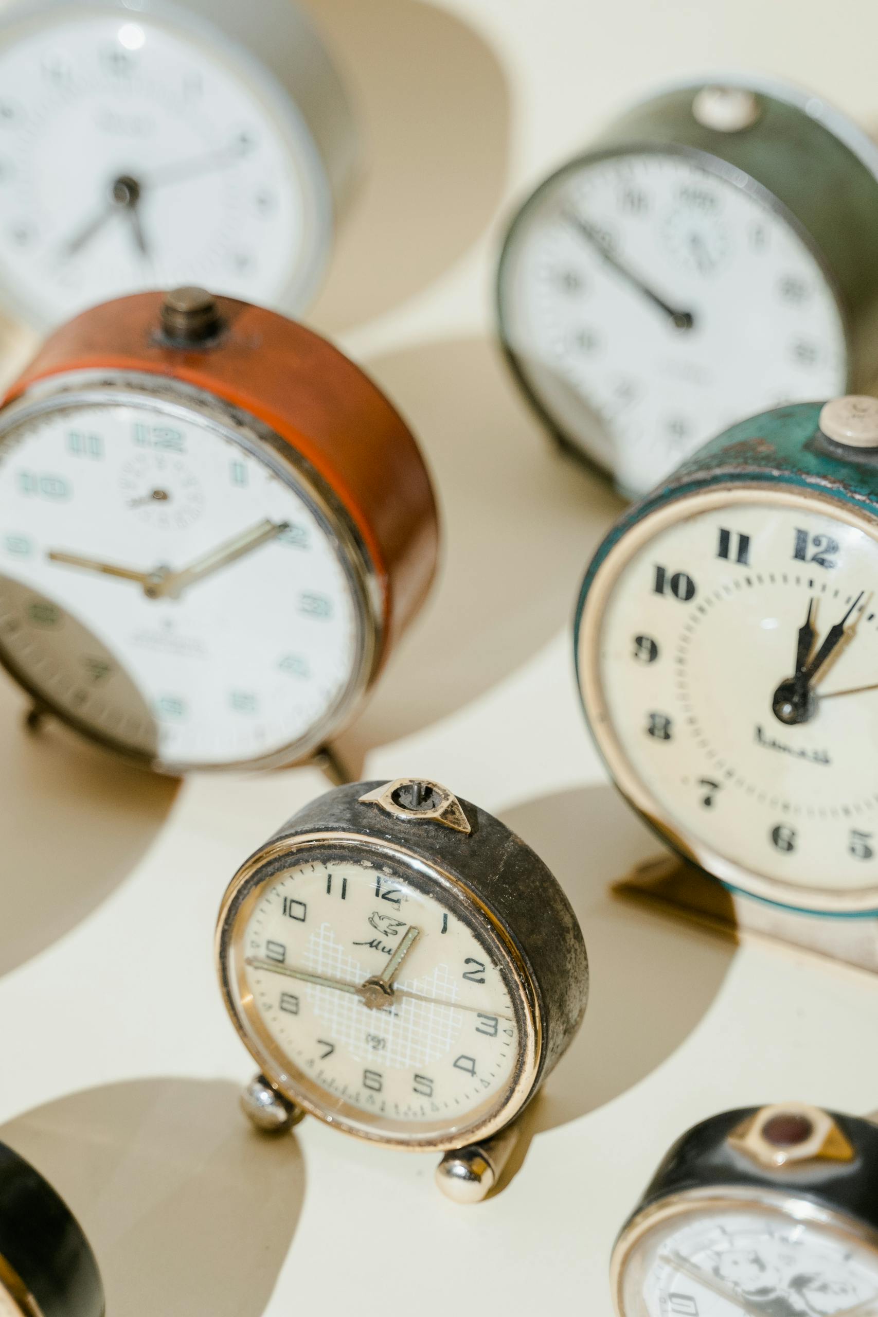A collection of vintage alarm clocks showcasing classic designs and rustic appeal.